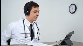 doctor speaks by video link with the patients