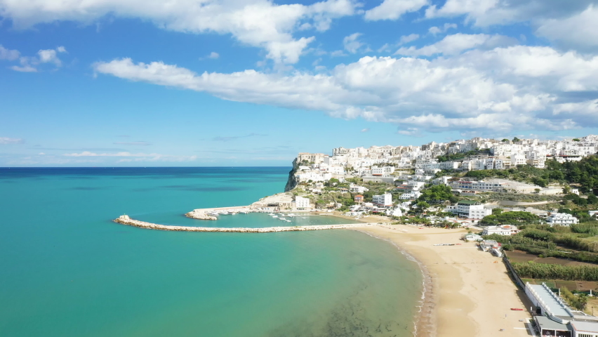 The town of Peschici, its marina and its fine sandy beach by the Tyrrhenian Sea in Europe, in Italy, in the Apulia region, in the province of Foggia, in Peschici