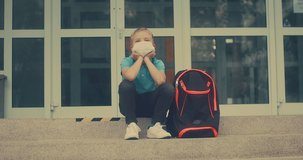 Boy, schoolboy in protective mask goes to school. 4K video