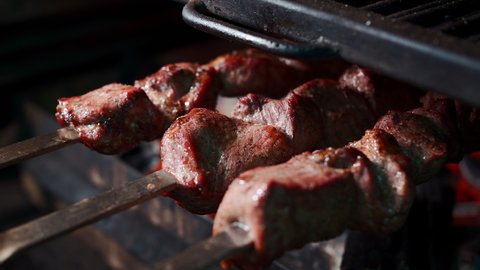closeup of preparation roasted shashlik meat on skewer on barbecue grill