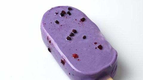 Lavender purple cold ice cream melt on white background. 4K video of ice cream.