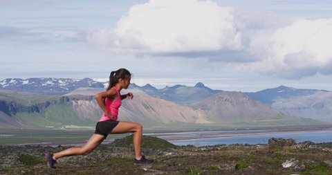 Fitness woman doing Pulse Lunges exercise. Female fitness model doing Lunge Pulses workout while exercising in Iceland nature landscape working out glutes, hamstrings and quadriceps