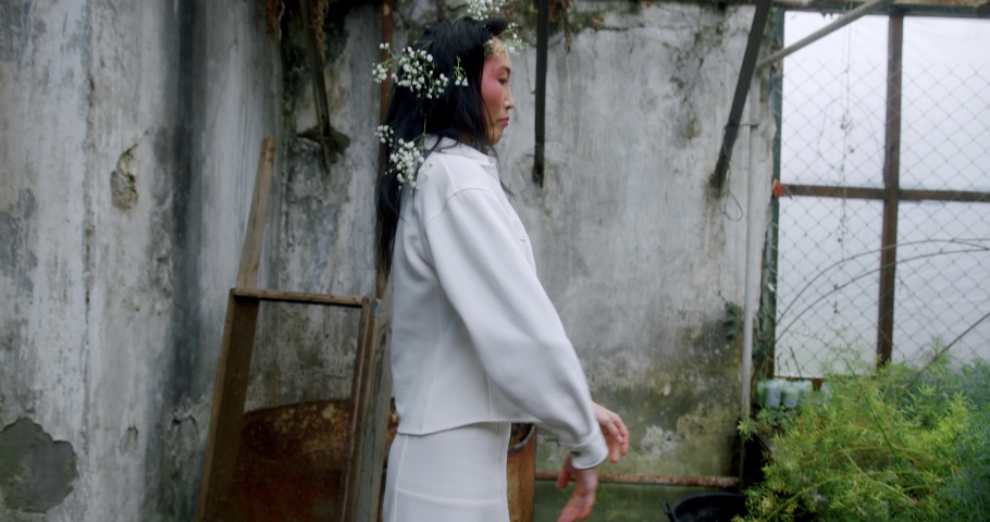 Beautiful asian girl with gypsophila flowers in her hairstyles dancing