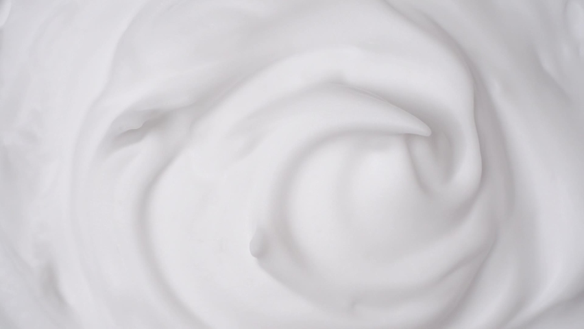 Foam swirl. Close view of thick shaving foam. Top view. Rotation | Shutterstock HD Video #1077561263
