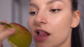 Woman biting tasty juicy pear close up. Healthy eating. Video with sound.