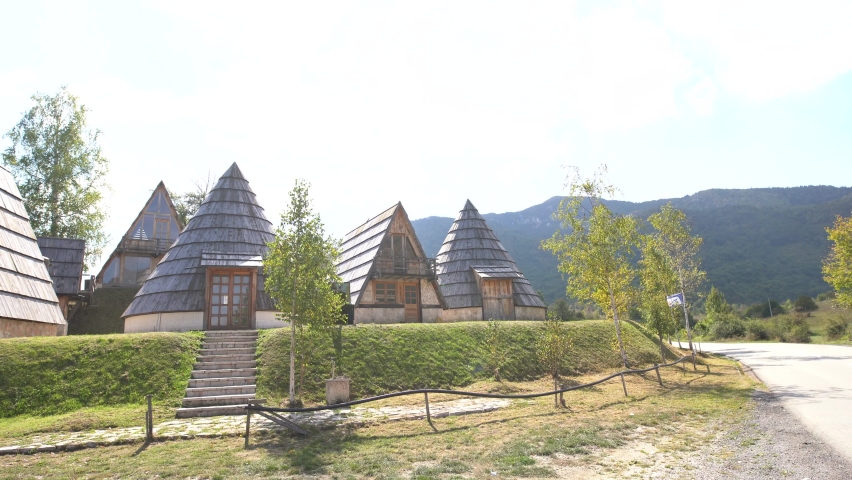 Triangular and conical houses at the foot of the mountains in Durmitor National Park