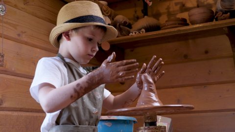 Sculpting clay pottery wheel child workshop craft. Art education. Molding clay child pottery art and craft kid. Making pottery artist boy clay shaping. Ceramic artist kid creative children development