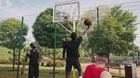 Professional sports. Team of millennial sportsmen engaged in basketball game at outdoor court in summer. Group of multiracial young people playing basketball on court at outdoors. - Powered by Shutterstock - Get 15% off with code: PIKWIZARD15
