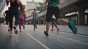 Close-up of legs of athletes in sports shoes. Rear view athletes runners train in the stadium. Young team of man and woman in sportswear. Like-minded club. - Powered by Shutterstock - Get 15% off with code: PIKWIZARD15