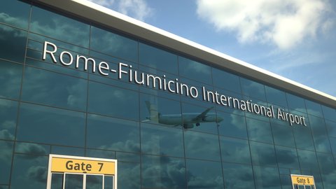 Commercial plane take off reflecting in the windows with Rome-Fiumicino International Airport text