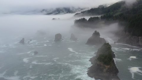 Fog drifts across the scenic coast of southern Oregon. This beautiful yet rugged and rocky part of the Pacific Northwest is found along the Samuel H. Boardman State Scenic Corridor.