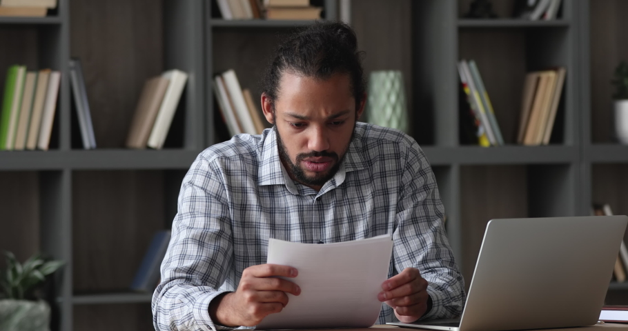 Stressed emotional depressed young african american man reading paper notification with bad news, getting bank loan rejection or dismissal notice, suffering from financial problems or having debt. Royalty-Free Stock Footage #1077590264