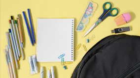 Stop motion animation of Multicolor school supplies are moving from black school backpack on yellow background. Back to school, education, childhood, primary school concept. Top view - Powered by Shutterstock - Get 15% off with code: PIKWIZARD15