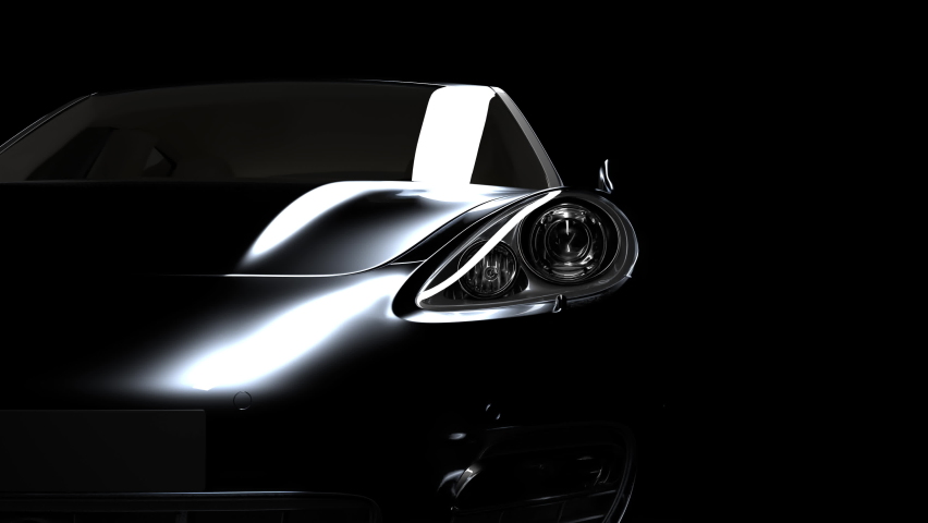 The black car gradually emerges from the darkness due to the illumination and disappears again in the darkness. close-up on headlights