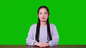 Young asian woman taking video calling. Green background for chroma key composition.