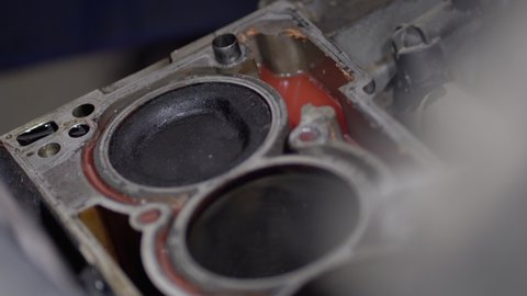Disassembled motor engine of a car on a repair at the mechanic.The cylinder block of the four-cylinder engine. Closeup