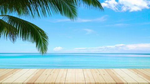Wood table on beach and coconut tree in summer. Sea view background. Nature and travel concept.