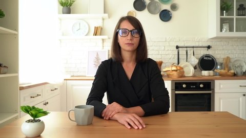 young business woman in eyeglasses talks to web camera making distance online video conference call. Female internet teacher doing distant chat working from home. Online work concept. Webcam view