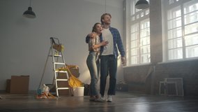 Cheerful couple admiring results of house renovation indoors. Amazed woman and man turning around in new apartment with tools for home repair. Happy family hugging indoors. - Powered by Shutterstock - Get 15% off with code: PIKWIZARD15
