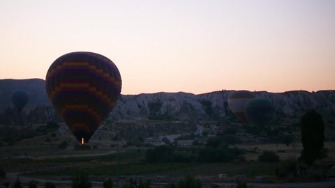 Gereme, Cappadocia, Turkey - 06.15.2021: Air balloons start flying. Air balloons takeoff in Cappadocia. Kapadokya, Gereme.