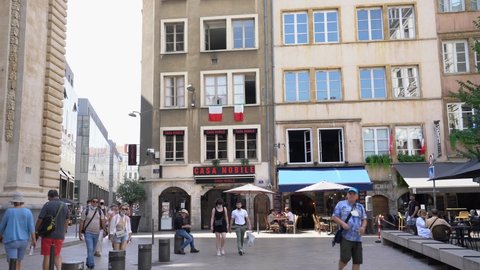Lyon, France - August 14, 2021 : Tourists stroll on the Place de l'Hopital near the Hotel Dieu in Lyon, France
