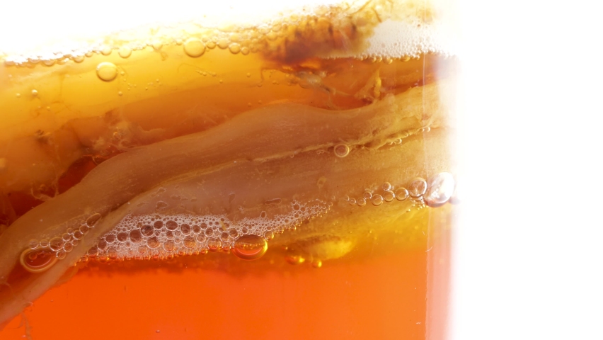 Anaerobic fermentation process of black tea kombucha, the CO2 gas bubbles that are produced are observed | Shutterstock HD Video #1077627080