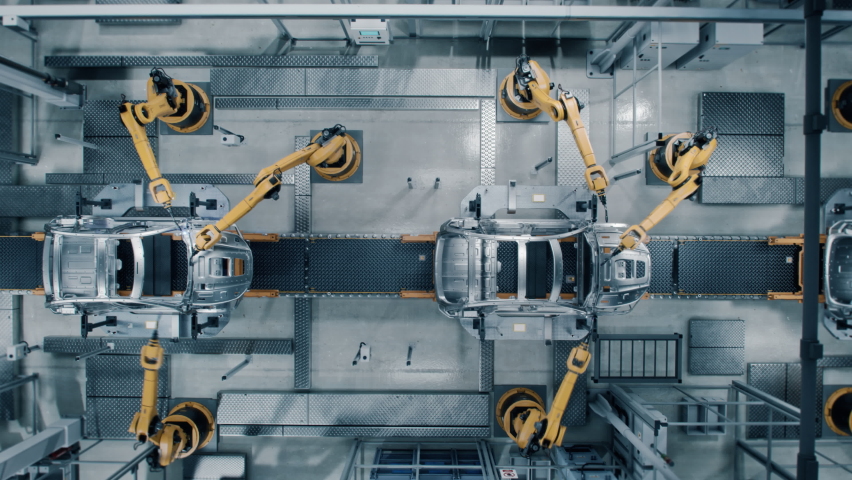 Aerial Car Factory 3D Concept: Automated Robot Arm Assembly Line Manufacturing Advanced High-Tech Green Energy Electric Vehicles. Construction, Building, Welding Industrial Production Conveyor Royalty-Free Stock Footage #1077627404