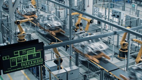 Car Factory 3D Concept: Automated Robot Arm Assembly Line Manufacturing High-Tech Green Energy Electric Vehicles. Construction, Building, Welding Industrial Production Conveyor. Fast Wide Shot
