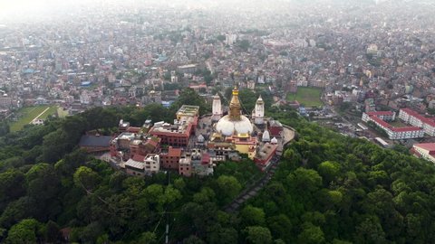 Cinematic Rising shot of the Monkey Temple in Kathmandu, Nepal. Also known as Swayambhunath Stupa, the monastery is build on top of a hill with the 360 degree panoramic view of the Kathmandu Valley.