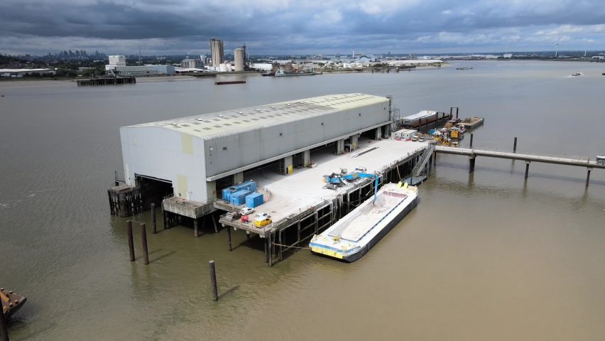 Barge Unloading at Dock on River Thames UK Essex drone footage