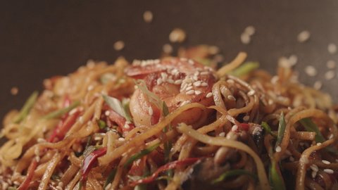 Fresh fried noodles with vegetables with shrimps served in black iron pan