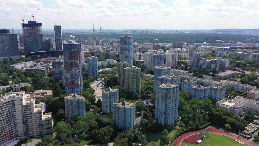 Nanterre, Paris suburbs, Hauts-de-Seine district, HLM social housing buildings and skyscrapers "The Aillaud towers" in Picasso quarter before rehabilitation.. Wide drone aerial view with Eiffel Tower Royalty-Free Stock Footage #1077643319