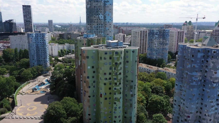 Nanterre, Paris suburbs, Hauts-de-Seine district, HLM social housing buildings and skyscrapers "The Aillaud towers" in Picasso quarter before rehabilitation.. Wide drone aerial view with Eiffel Tower Royalty-Free Stock Footage #1077643319