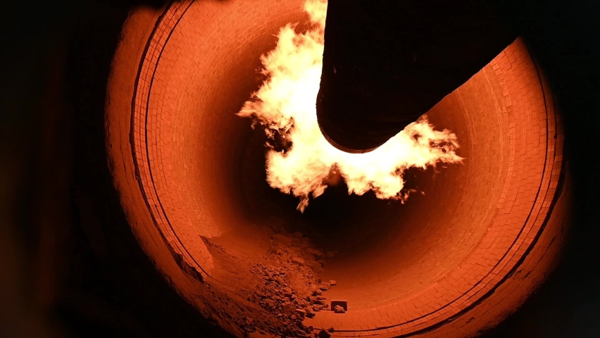Flame in rotary kiln, cement plant, in slow motion during clinker production process HD. Royalty-Free Stock Footage #1077644282