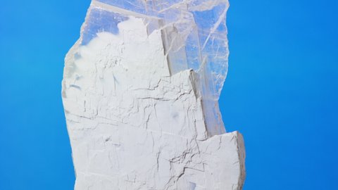 Traditional oriental medicine and crystals for Chinese medicine. Gypsum Rubrum or Gypsum Fibrosum. Large transparent crystal on a blue background, magic and medicine.