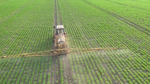 Application of water-soluble fertilizers, pesticides or herbicides in the field. View from the drone.
