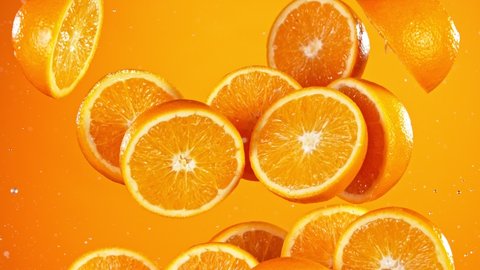 Super Slow Motion Shot of Flying Fresh Orange Cuts at 1000 fps. Video Stok