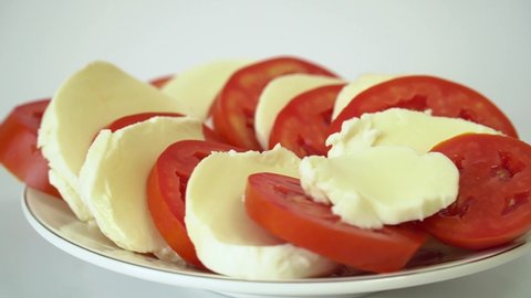 Italian tomato and mozzarella caprese salad rotate on their axis