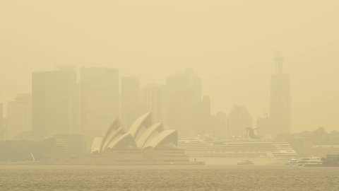 SYDNEY, NSW, AUSTRALIA. DECEMBER 10 2019. Cruise liner and Sydney Opera House hidden in smoke from the 2019 catastrophic bushfires that shocked the world.