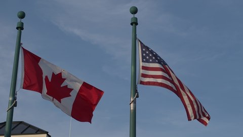 Canada flag and USA flag at custom crossing border united states of america free exchange