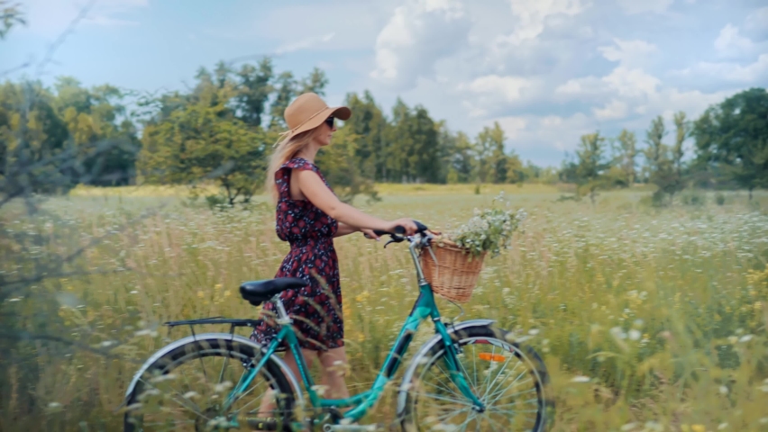 Cyclist Lady Moving On Bike On Countryside.Woman Cyclist Riding On Bicycle In City Park.Woman In Hat Enjoying Summer.Happy Beautiful Girl Cycling With Bike.Girl Cycling On Bike With Basket At Vacation Royalty-Free Stock Footage #1077655400
