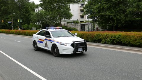 Coquitlam, BC, Canada - June 12, 2016 : The police car with siren lights flashing on Festival Coquitlam Grand Parade with 4k resolution.