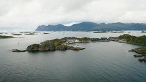 Flying around the Hamn i Senja village located on the Senja Island in northern Norway. This famous tourist attraction is surrounded by beautiful fjords and mountains. 4K UHD video.