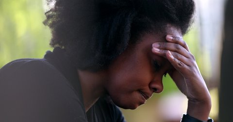 Frustrated Black woman shaking head in regret