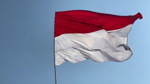 Indonesia and Monaco national flag with white cloudy sky background, in moderate wind