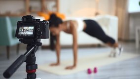 Online fitness training via camera screen with blurry lady