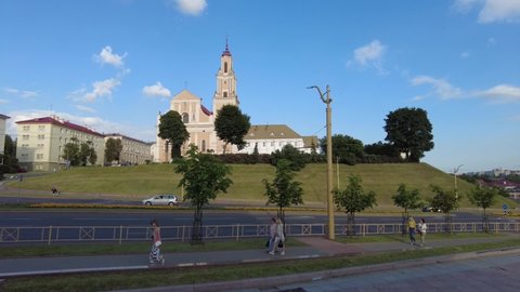 Grodno, Belarus - July 24, 2021: Timelapse of street traffic in Grodno with the famous Bernardine Church at the background