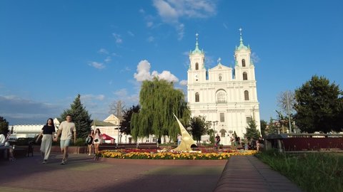 Grodno, Belarus - July 24, 2021: Timelapse of Soviet square in Grodno with famous Francis Xavier Cathedral, Farny the Jesuit Catholic Church on the background