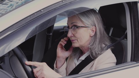 Nervous business woman making call sitting in car waiting to connection, roaming
