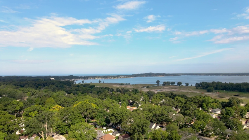 Aerial pan up over Muskegon Lake in the Lakeside neighborhood of Muskegon.